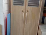 a cabinet and a refrigerator in a room next to each other