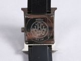 a close up of a watch on a white surface