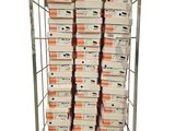 many boxes of pizza stacked on a metal rack
