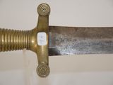 a close up of a sword with a gold handle