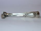 a silver spoon with a bunch of grapes on it