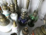 many different types of antique lamps on the table