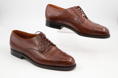 two pairs of brown leather shoes with laces on them