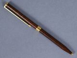 a wooden pen sitting on top of a gray surface