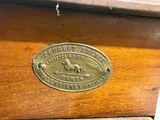 a close up of a brass plate on a wooden cabinet