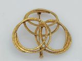 gold plated metal brooch with four intertwined rings