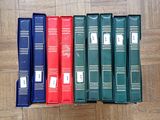 five books that are lined up on a wooden floor