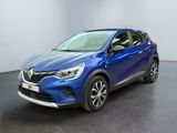 un SUV Renault C-HR bleu garé dans un showroom