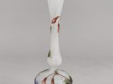 a close up of a glass vase on a white surface