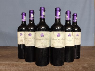 six bottles of wine sitting on top of a wooden table