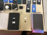 a lot of cell phones that are sitting on a table