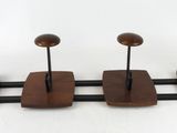three wooden birds are perched on a metal stand on a white background