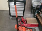 a picture of a red hand truck with tools on the floor