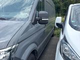 two vans parked next to each other in a parking lot