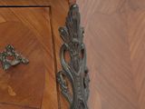 a wooden cabinet with a marble top and brass handles