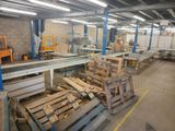 several pallets of wood are stacked on pallets in a warehouse