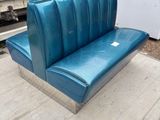 a blue bench that is sitting on a wooden floor