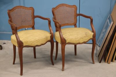 pair of cane back chairs with yellow upholstered upholstered cushions