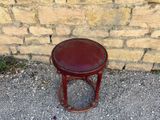 a small red stool sitting on the pavement
