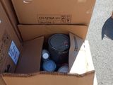 a cardboard box with a black barrel inside of it