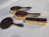 three brushes sitting on top of a table next to each other