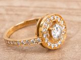 an image of a diamond ring on a wooden surface