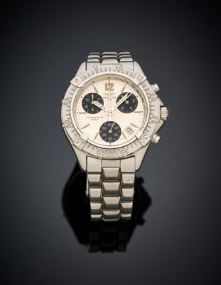 a close up of a watch on a black surface with a black background