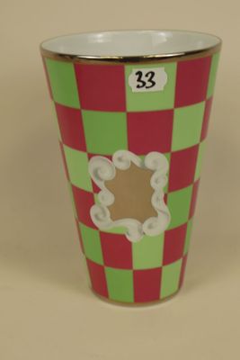 a cup with a red and green checkered pattern on it