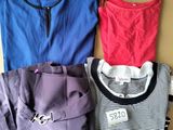 three shirts and a skirt on a cardboard box with a price tag