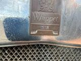 a close up of a car ' s grille with a sign on it