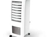 a white air cooler sitting on top of a white table