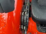 a red vehicle with a black seat and a yellow seat