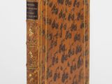 an old book with a brown cover and black writing on it