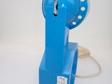 a blue telephone with a cord attached to it