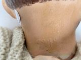 a close up of a mannequin head wearing a sweater