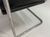 a metal chair with a black seat and a black seat