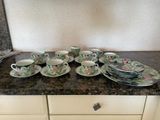 a lot of plates and cups on the counter