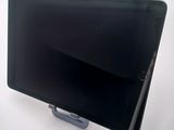 a tablet computer sitting on a stand on a white surface
