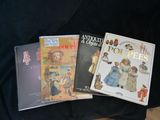 three children ' s books are sitting on a black cloth