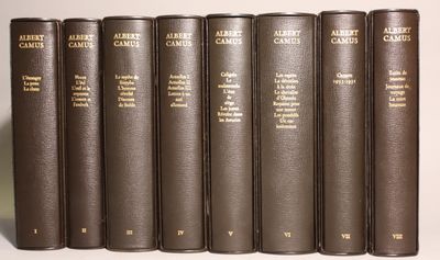 six books are lined up in a row on a white surface