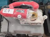 a red blower sitting on top of a table next to other tools