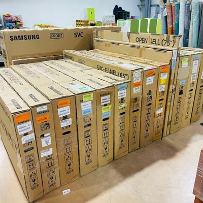 boxes of samsung electronics are stacked on top of each other in a store
