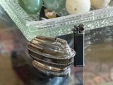 a silver object on a glass table next to a camera