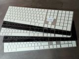three keyboards sitting on top of each other on a table