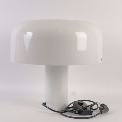 an image of a white table lamp with a cord plugged into it