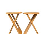 two wooden stools with crossed legs on a white background