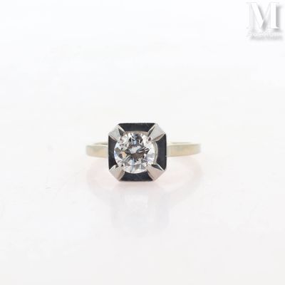 a close up of a ring with a diamond on it