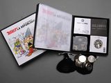 a picture of a box containing a watch and a coin
