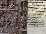 an old carved wooden table with a stone wall in the background
