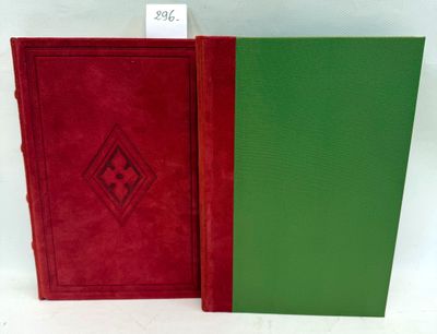 two red and green books sitting next to each other on a white surface